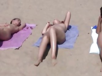 Shy teen pops her top off for all the beach goers