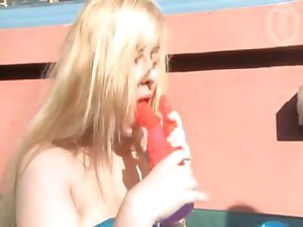 Blonde teen gets her dildo wet by licking it and then plunges it in