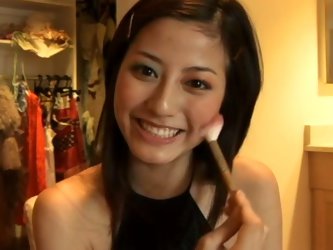 Brunette babe Yumi Sugimoto from Japan is cute. She puts on her maskara for the mild seduction show in the kitchen. Well, she just does everyday stuff