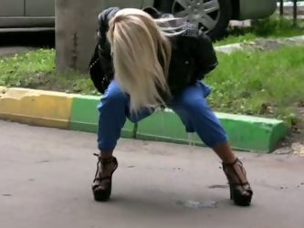 Young amateur Russian blonde lady has been filmed when she squatted and pissed in public. Her pants are wet and she changes it to leopard print tight 