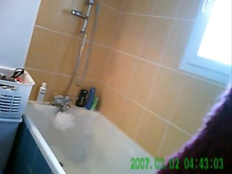 Homemade voyeur movie shows a sexy brunette chick with a hairy pussy getting into the bathtub and soaping up her irresistible body while a hidden came