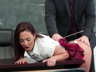 A hot chick makes a move on her teacher in the classroom