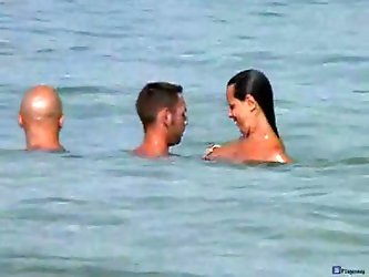 A couple take their girlfriend along for a nice swim at a nude beach. She takes the camera out and gets horny while filming their naked bodies in the